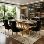 A luxury dining room set featuring a rectangular marble-top dining table with a gold geometric circular base, surrounded by six black tufted velvet chairs with gold legs, set on a geometric patterned rug.