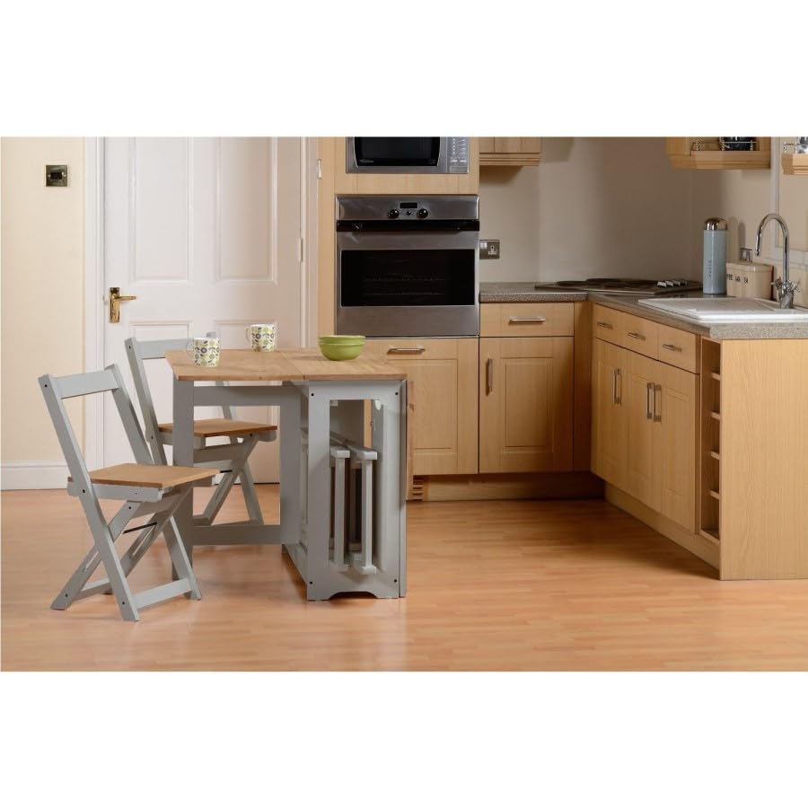 Kitchen with wooden cabinets, a sink, and a small table with chairs.