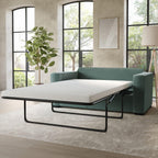 Green sofa bed in a room with large windows and a plant.